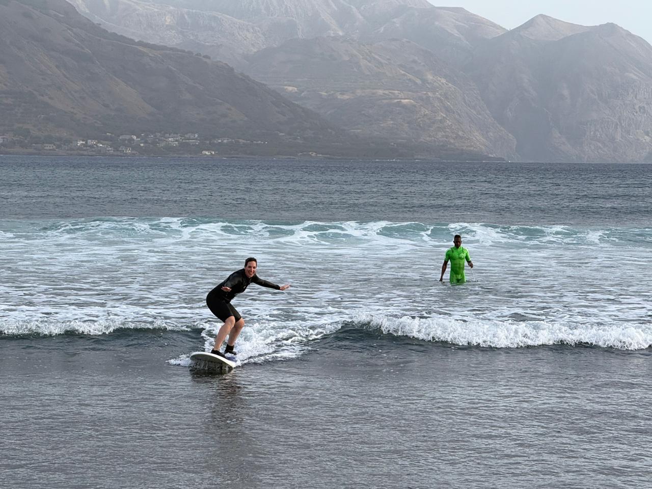 Woman surfing with Kabungo coaching